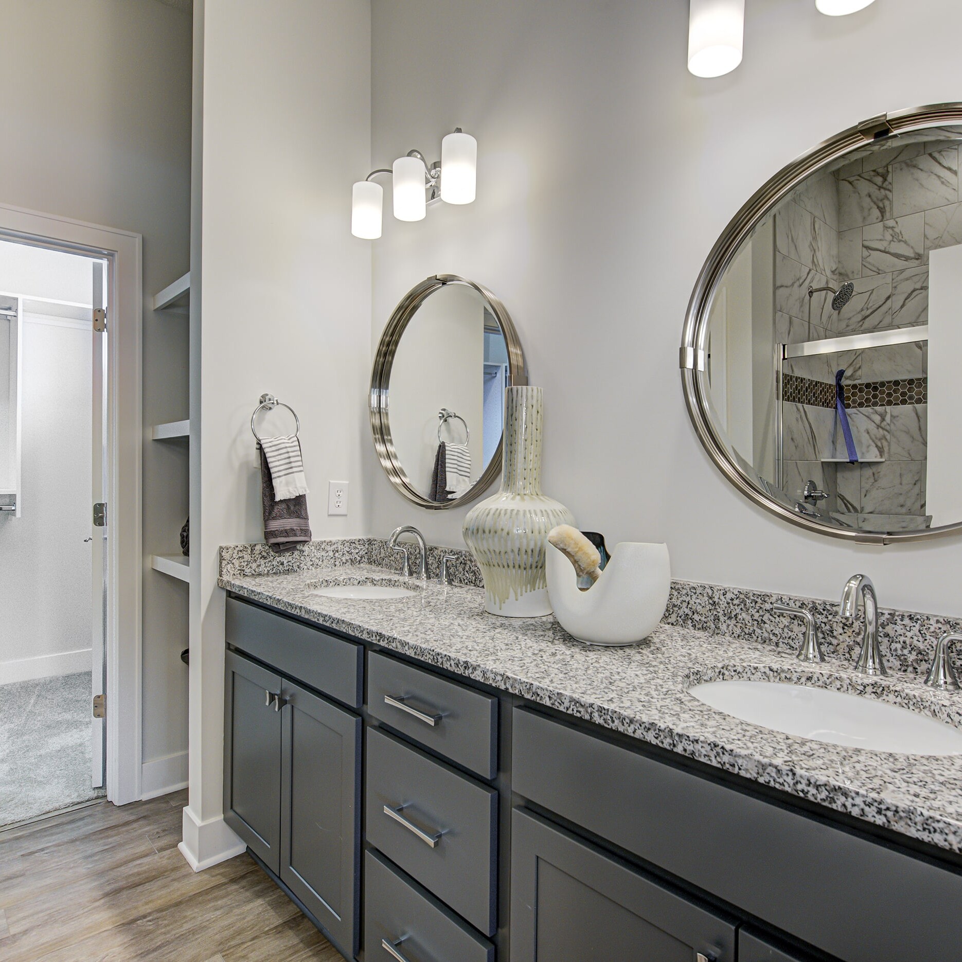 A bathroom with two sinks and a mirror.