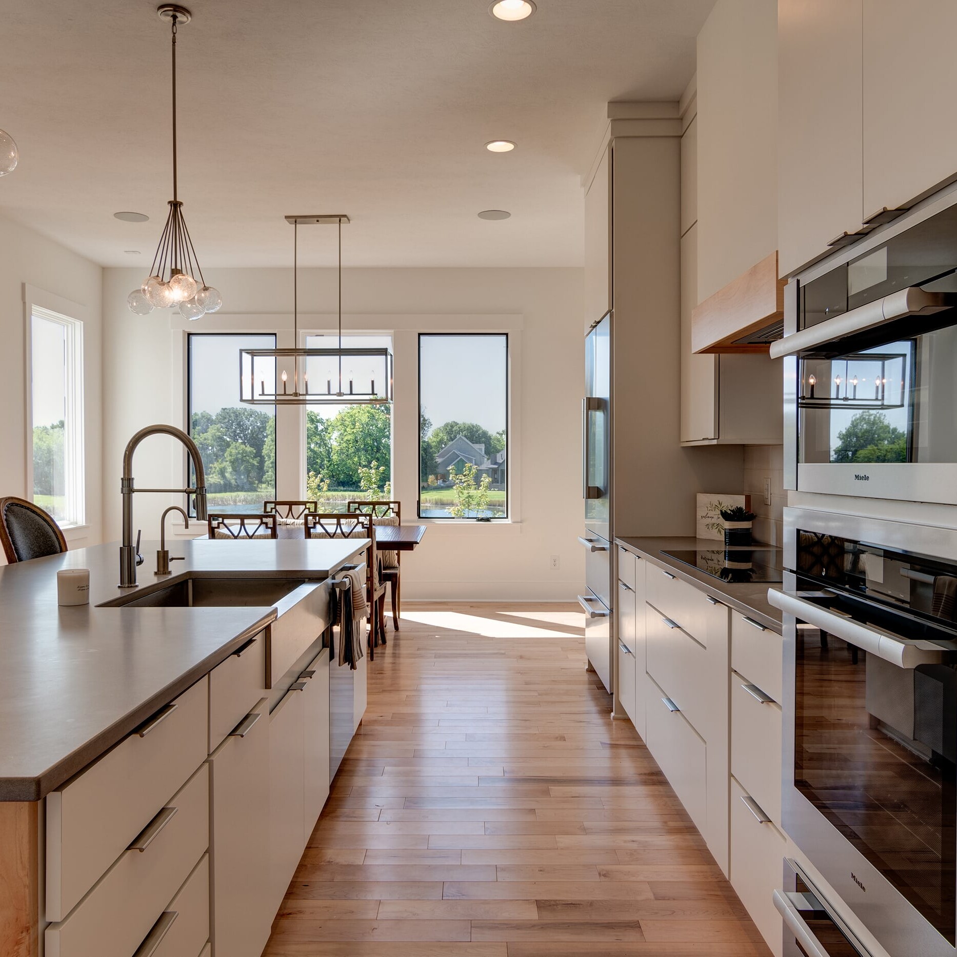 A kitchen with stainless steel appliances and hardwood floors.