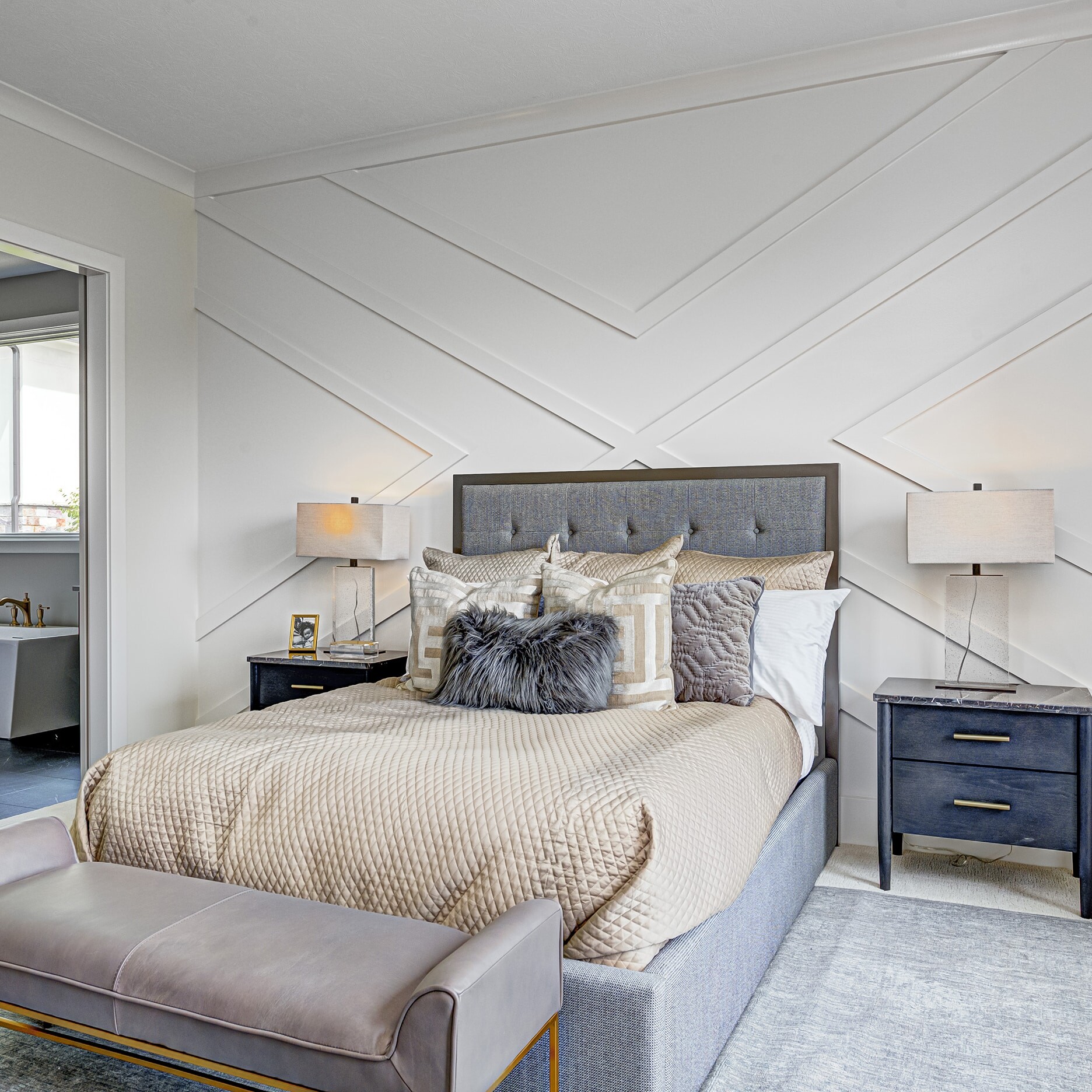 A bedroom with a bed and a bedside table.