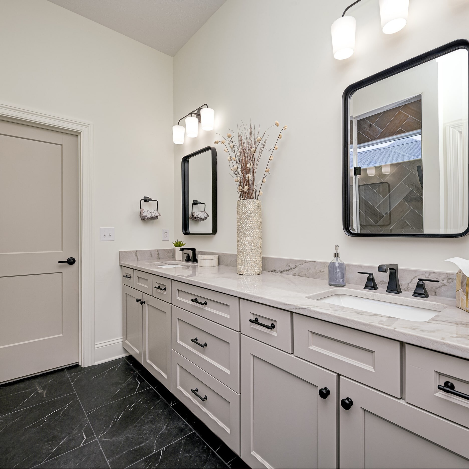 A bathroom with two sinks and a mirror.