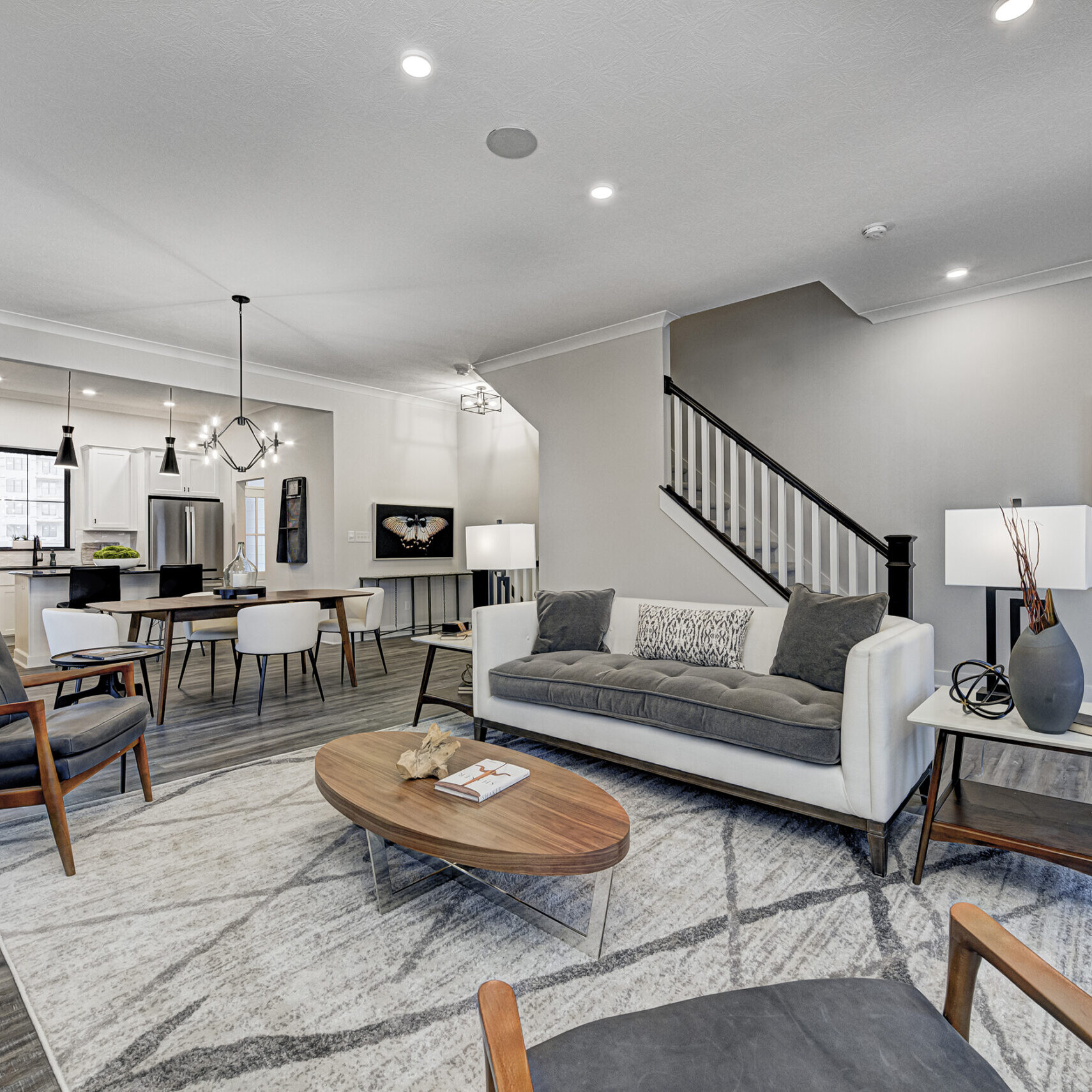 A living room with hardwood floors and a staircase, custom-built by a Custom Home Builder in Fishers Indiana.