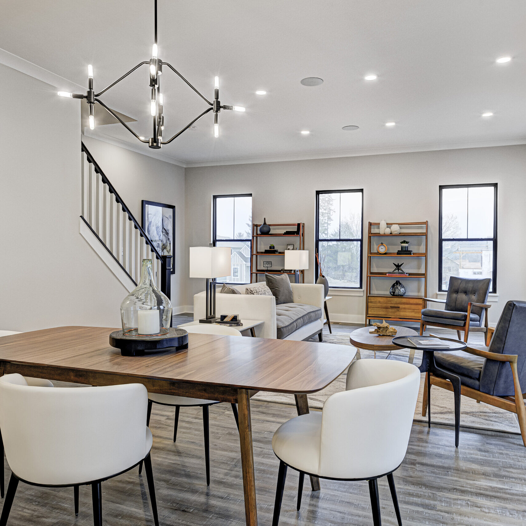 A living room with a dining table and chairs, perfect for custom home builders in Carmel Indiana or Fishers Indiana looking to create new homes.