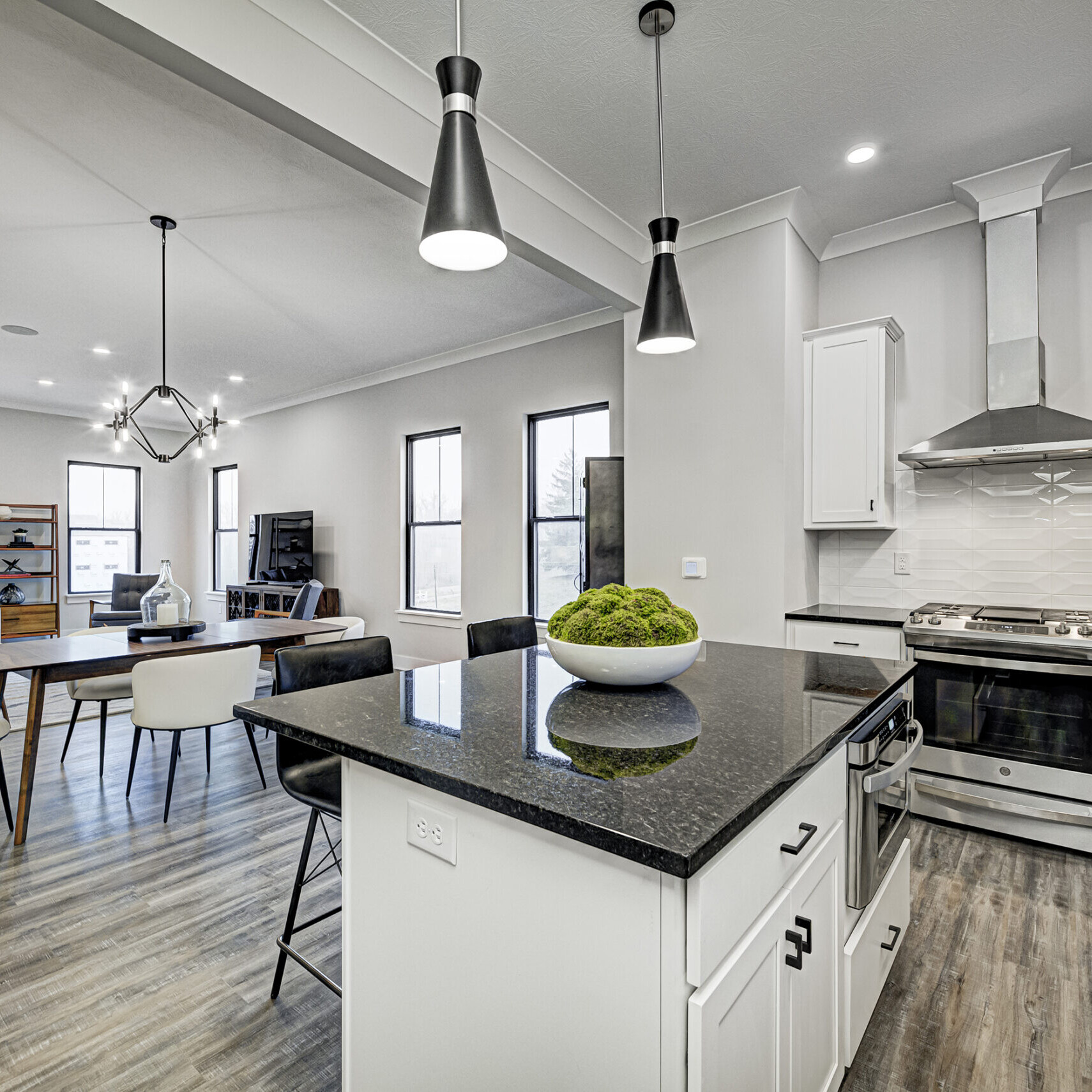 An open kitchen with hardwood floors, perfect for Indianapolis Custom Homes and custom home builders in Fishers Indiana and Carmel Indiana.