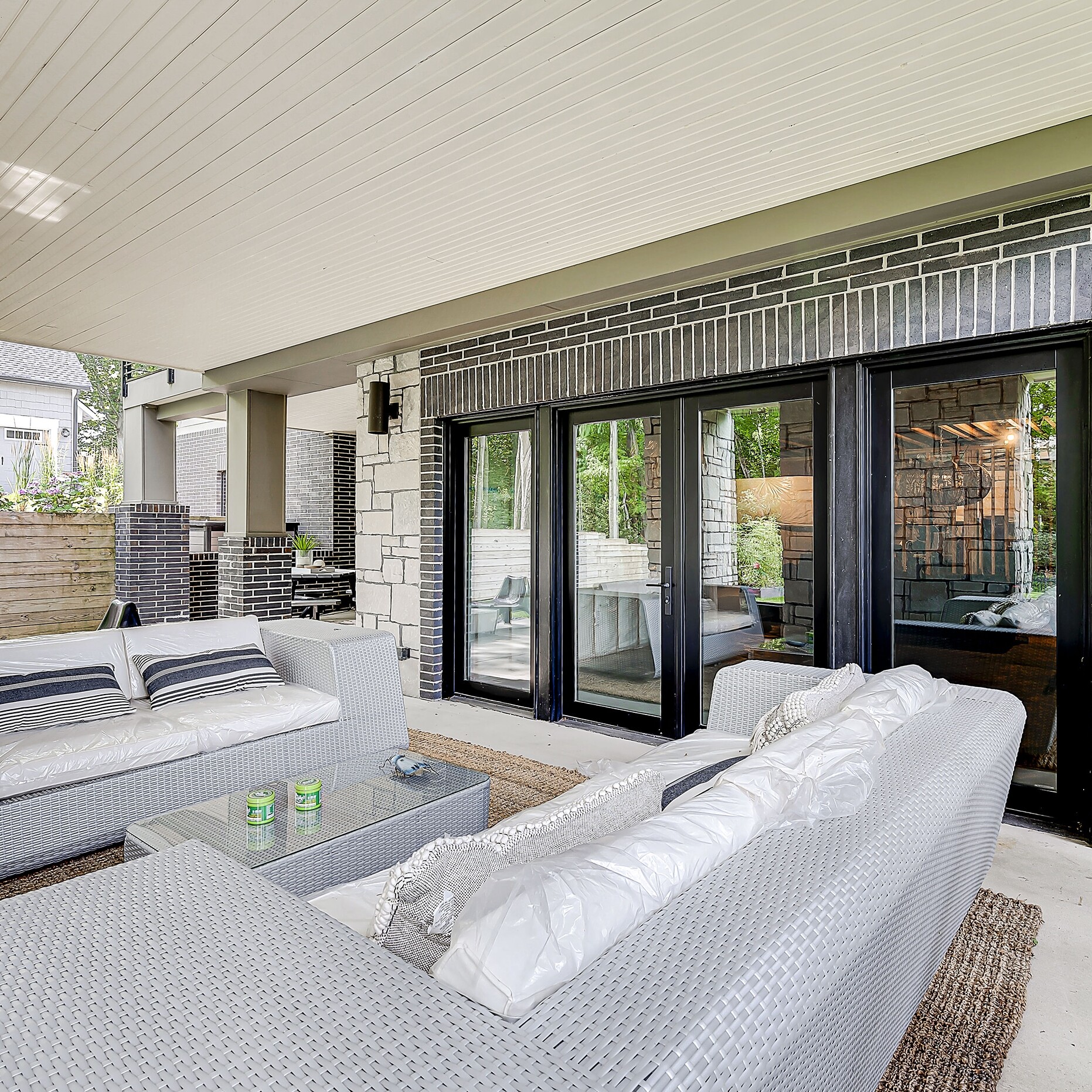 A patio with a white couch and a coffee table.