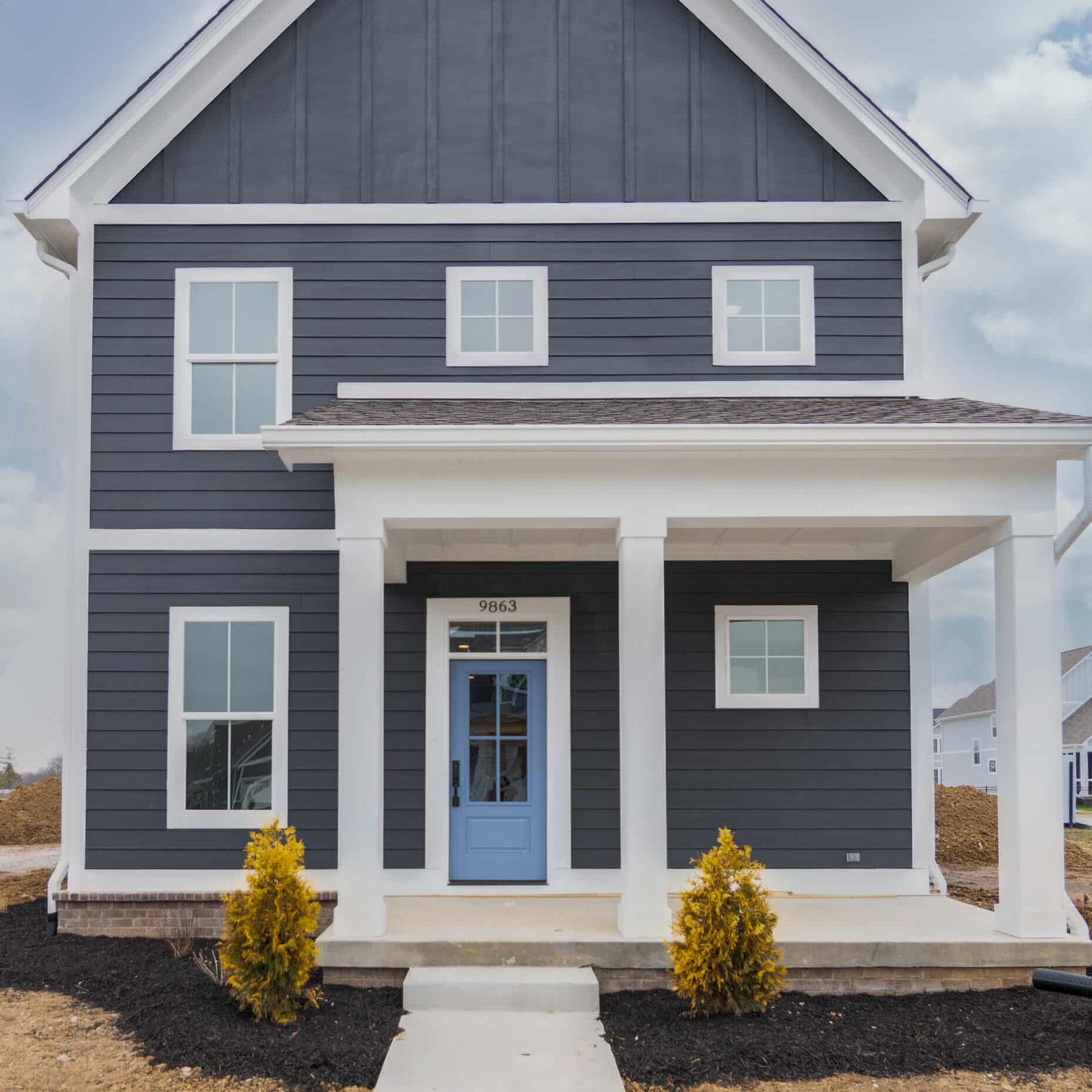 The exterior of a home with a blue door.