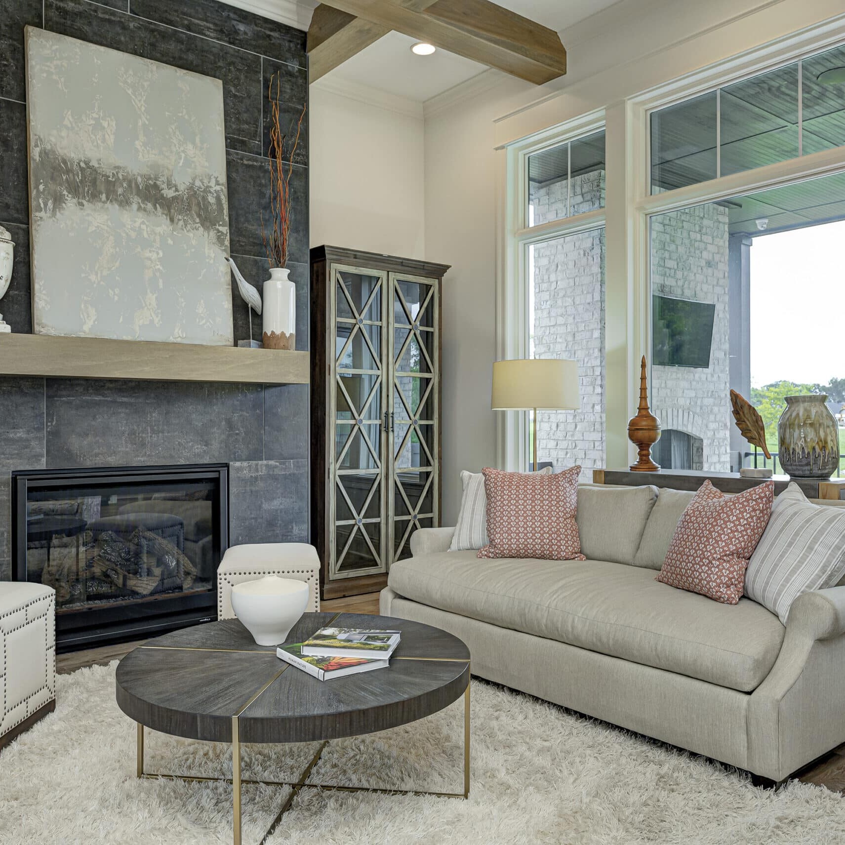 A custom living room with a fireplace and large windows.