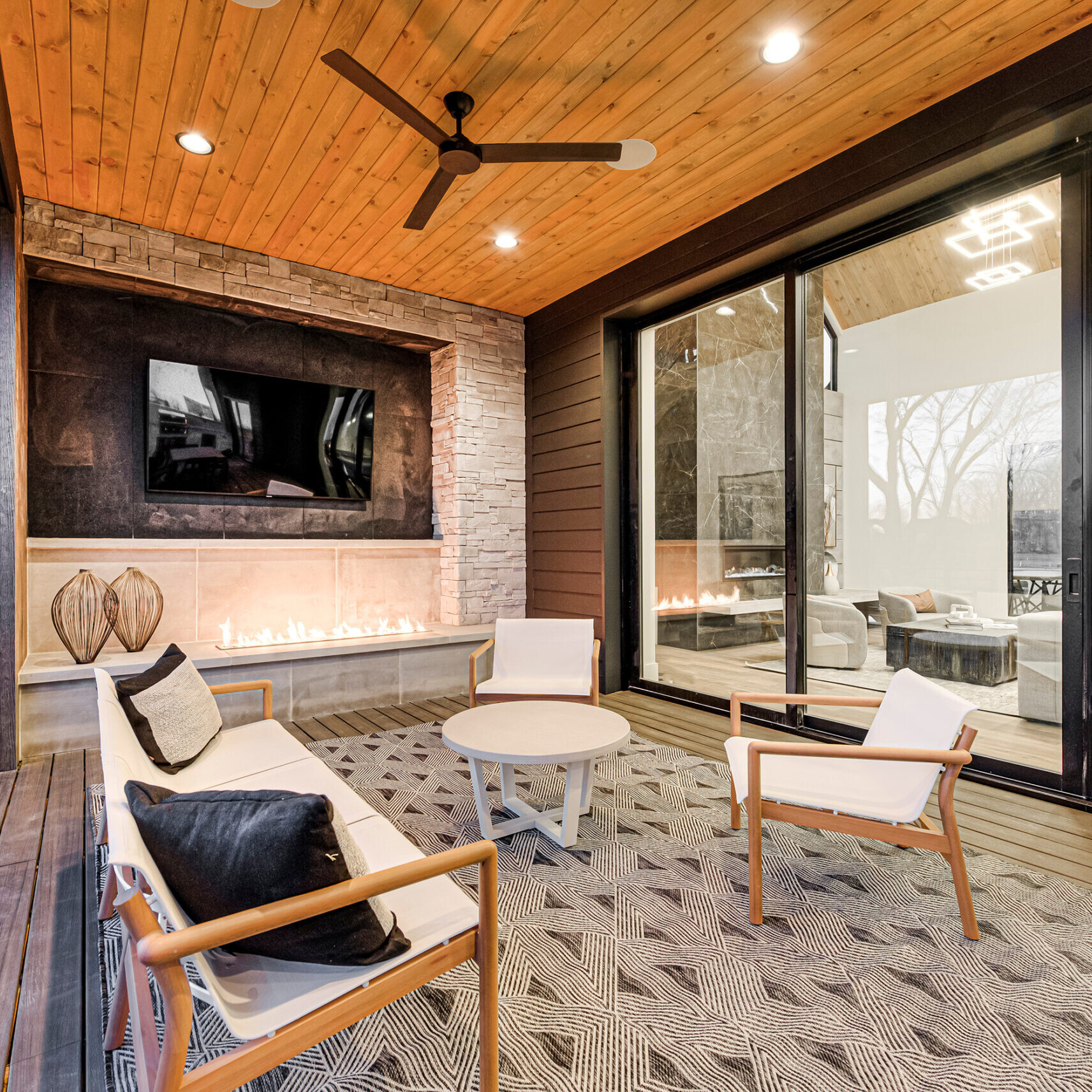 A modern living room with a fireplace and tv.
