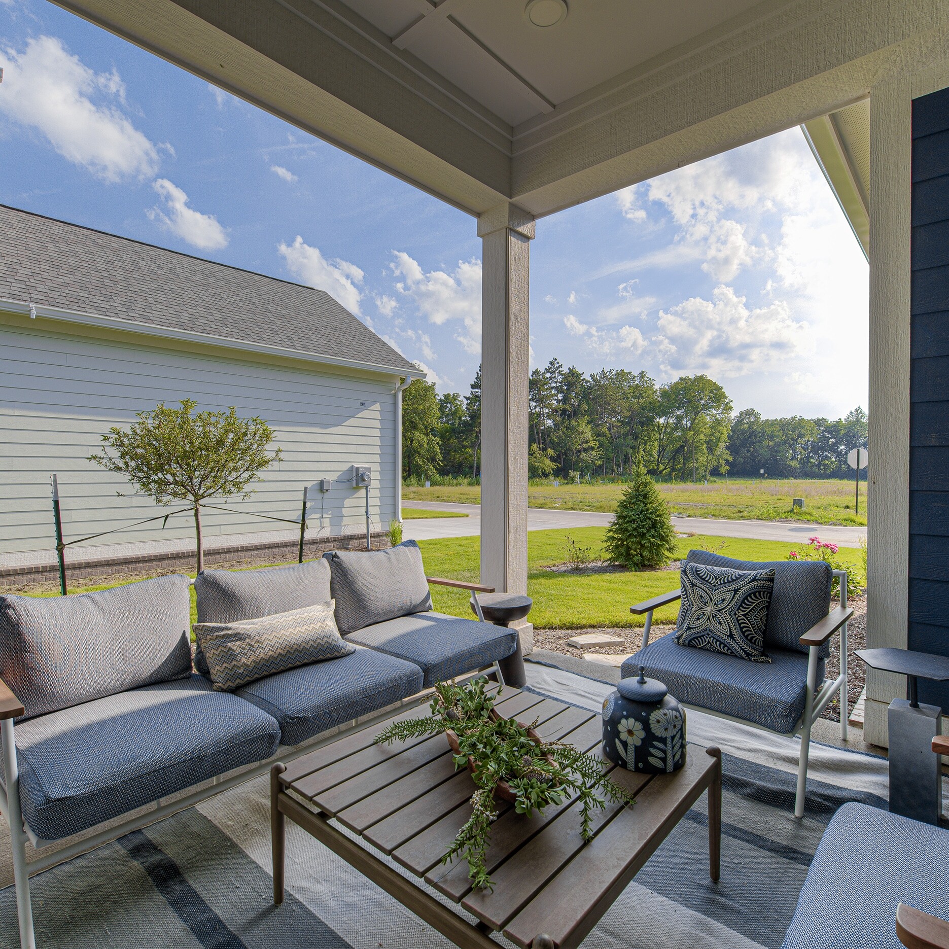 A patio with blue furniture and a table.