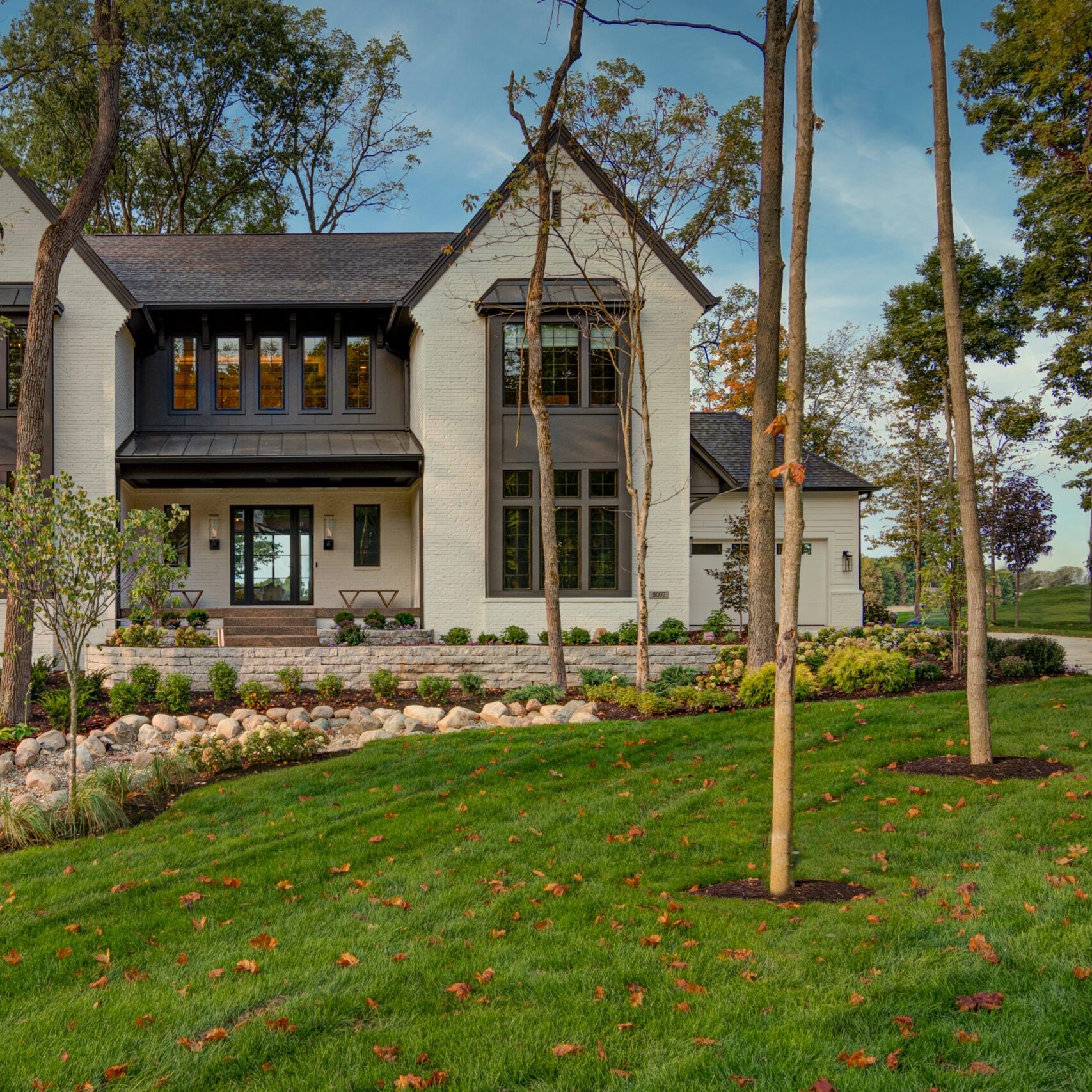 A home with a large lawn and trees.