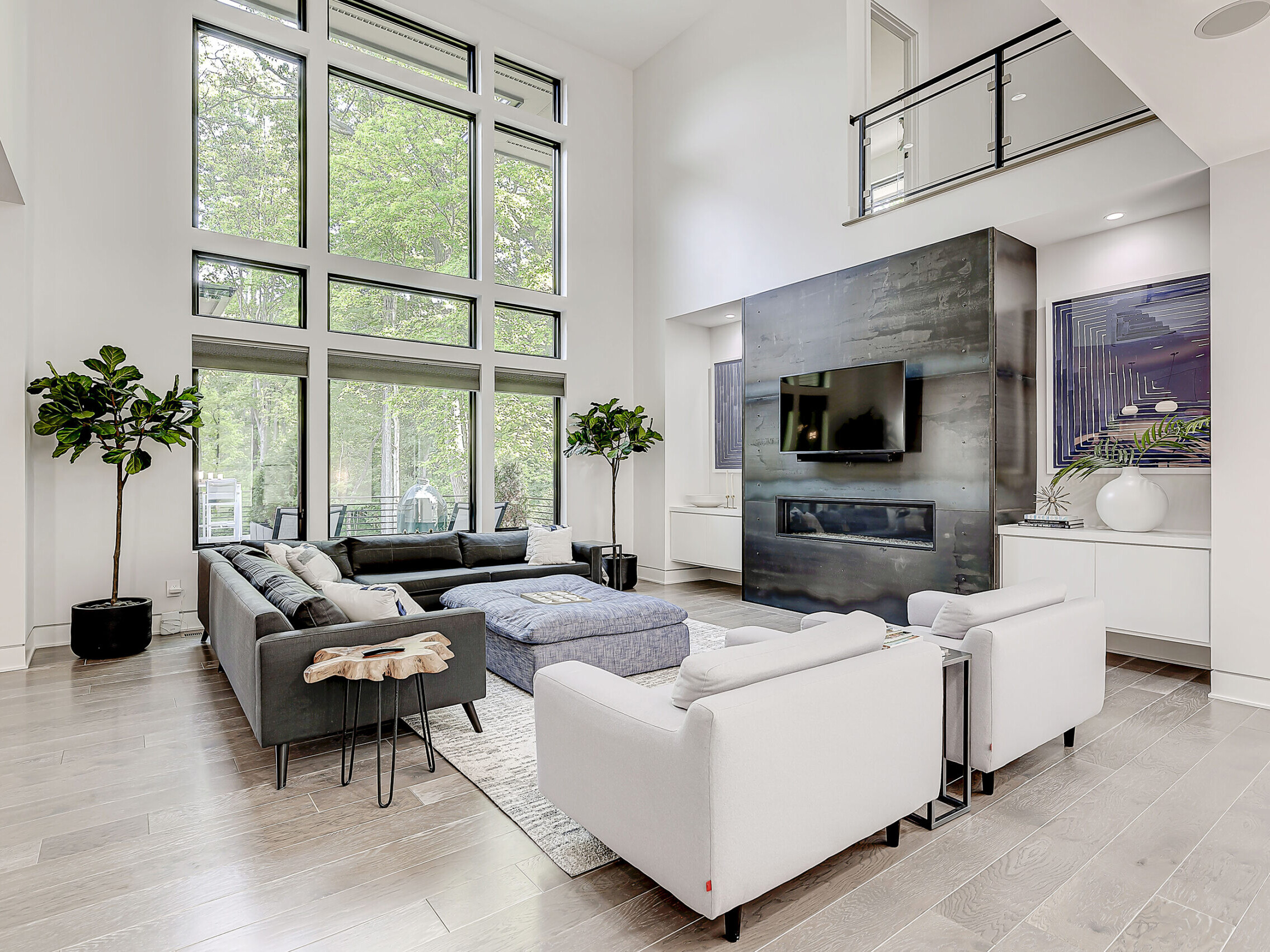 A spacious living room with a fireplace and expansive windows, perfect for showcasing the beautiful views.