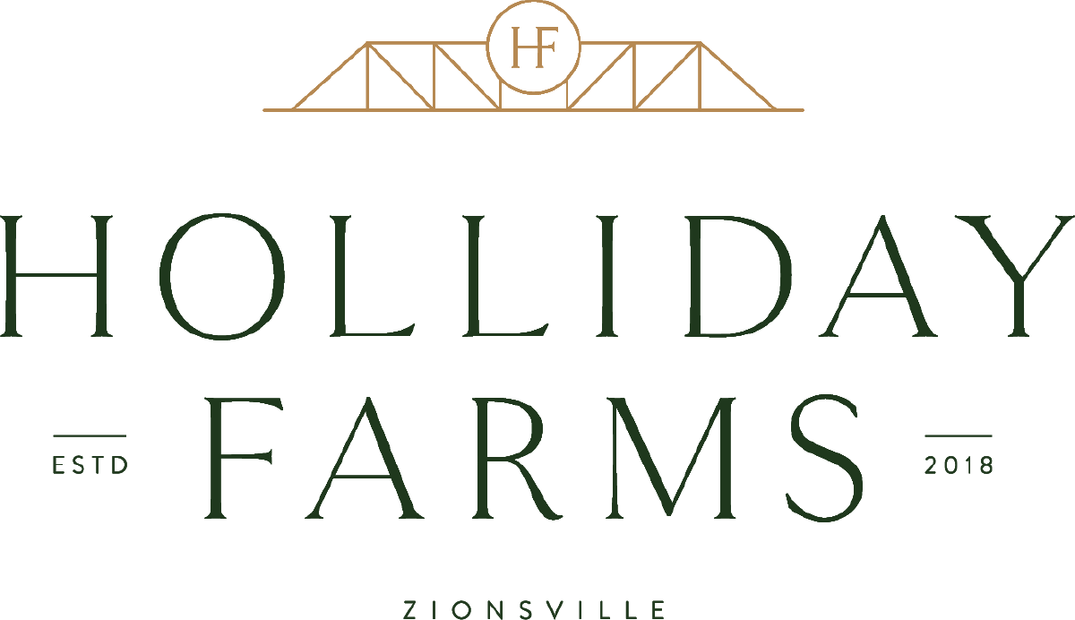 Luxury custom home builders logo on a green background at Holliday Farms.